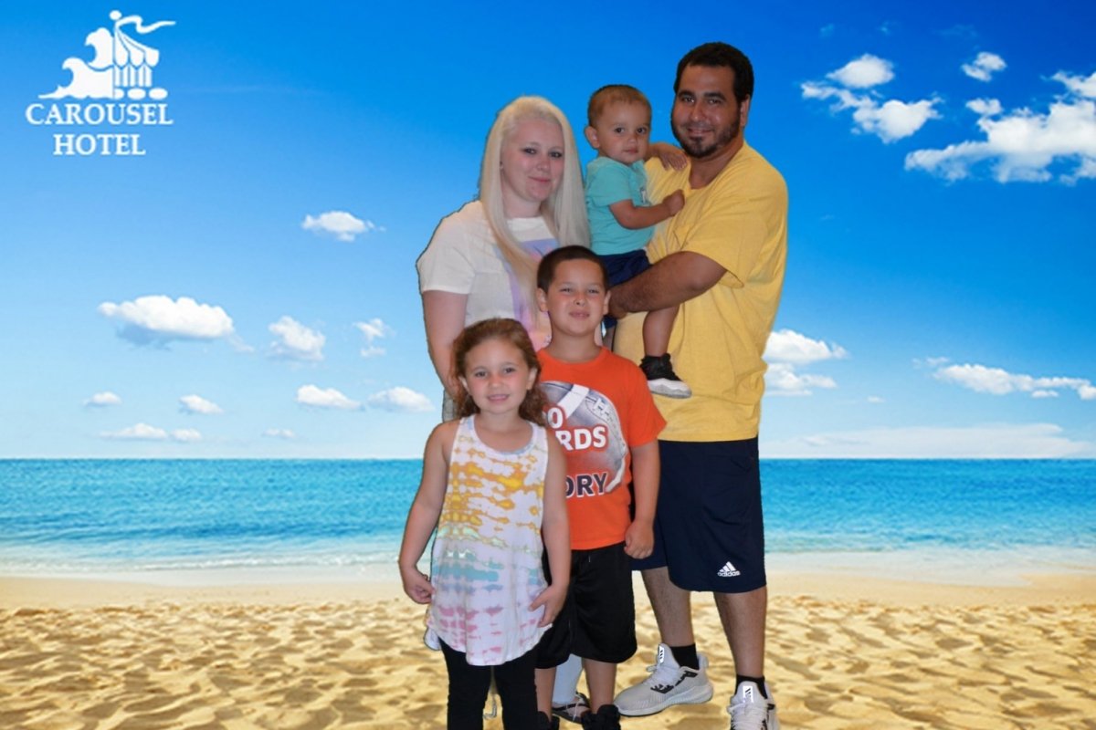 A family photo infront of the beach.