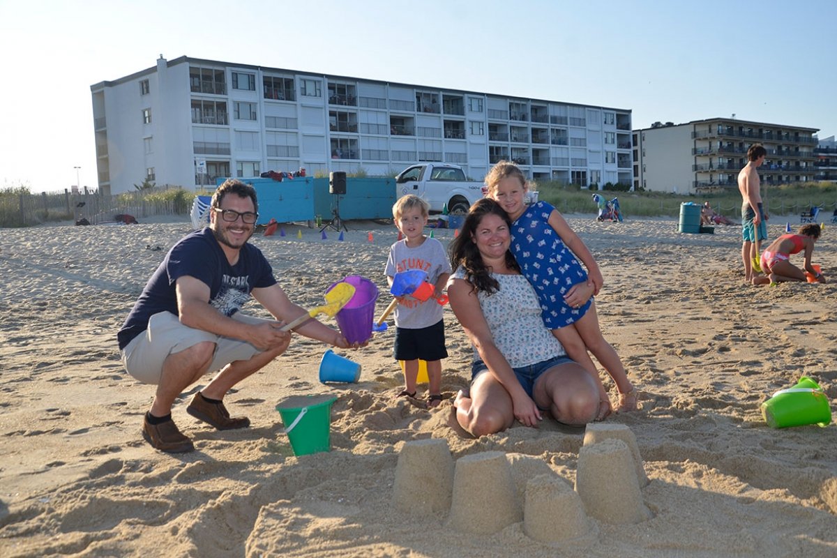 A family building sand castles on the beach.