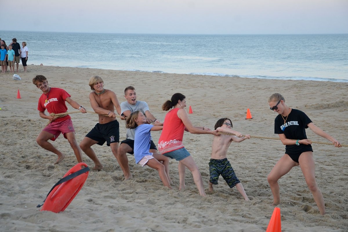 A game of tug of war on the beach.