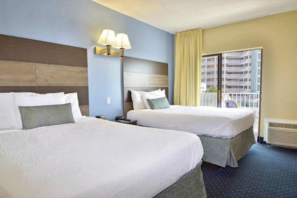 Two queen beds in the suite of Coastal Palms.