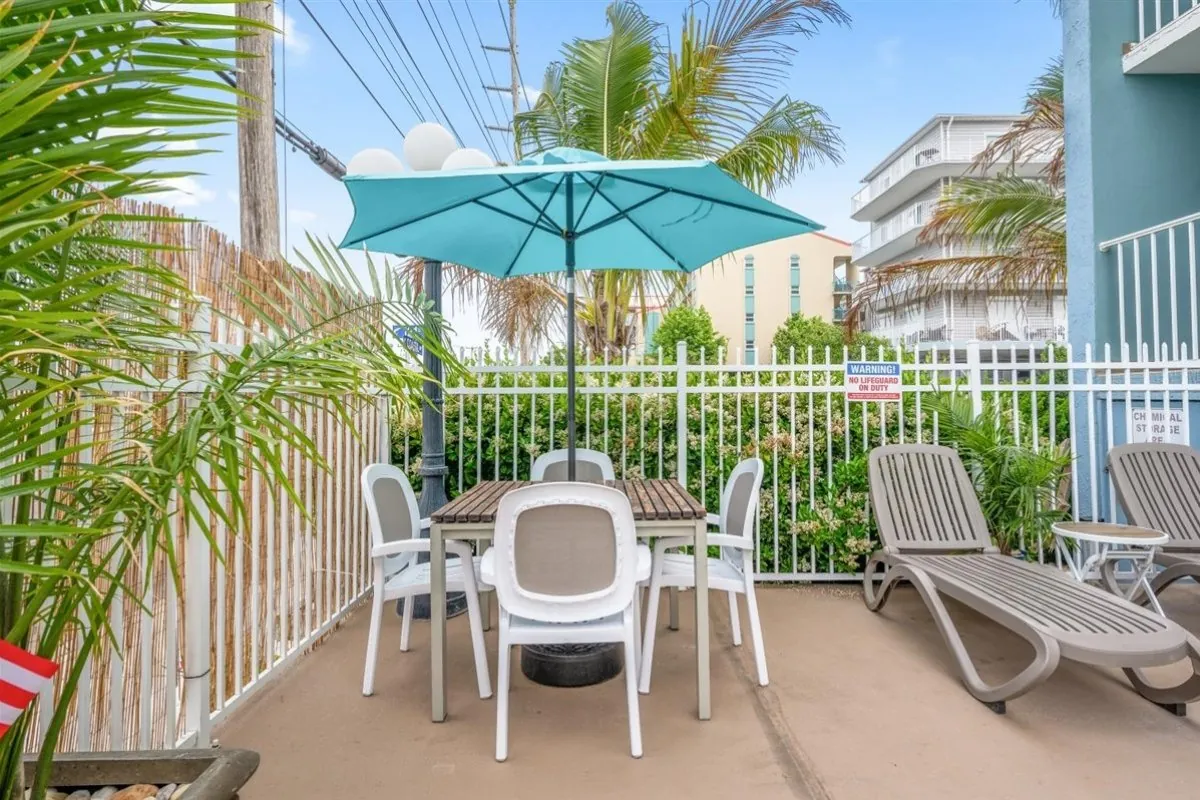 Lawn chairs and tables by the pool area.