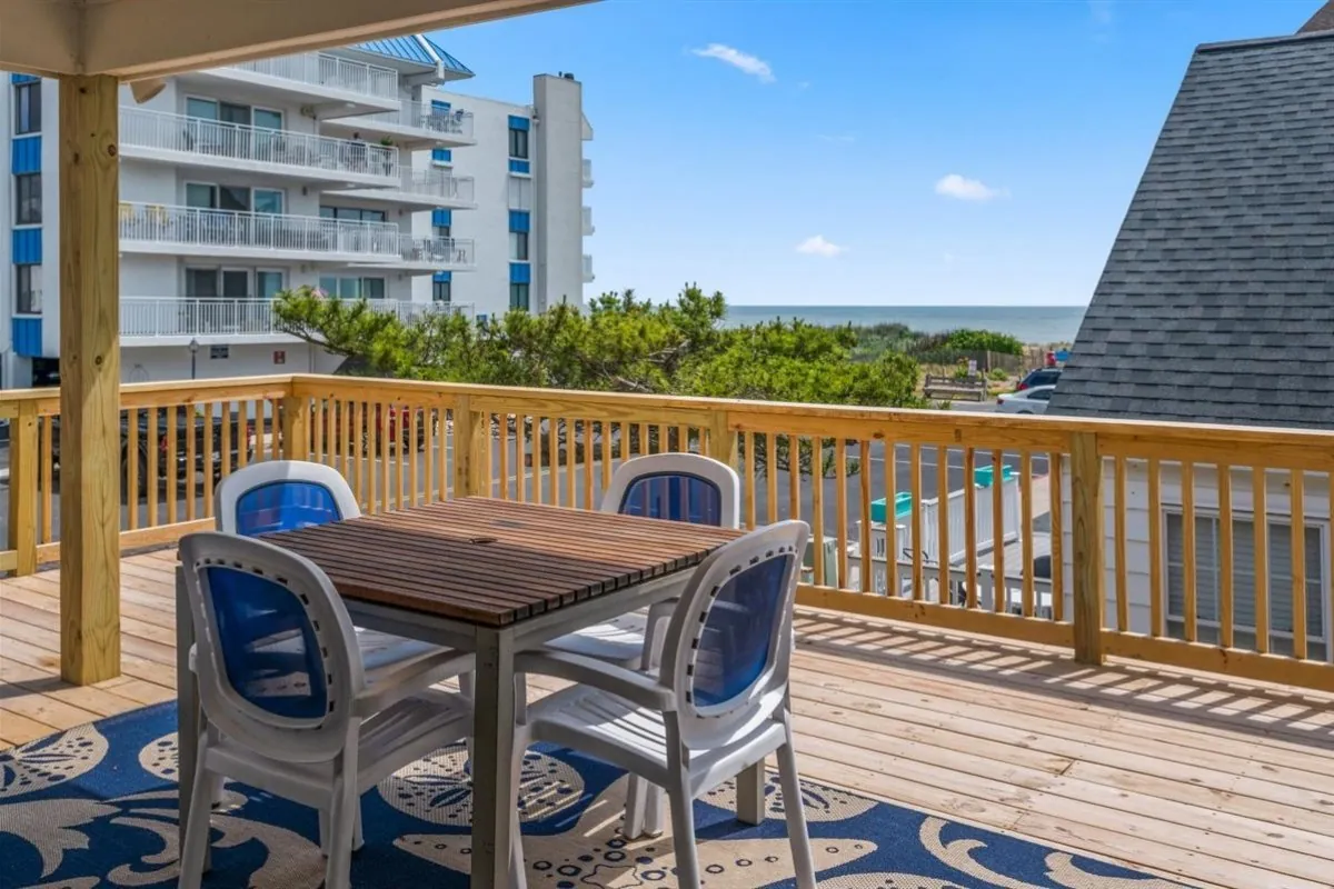 Table and four chairs on a deck.